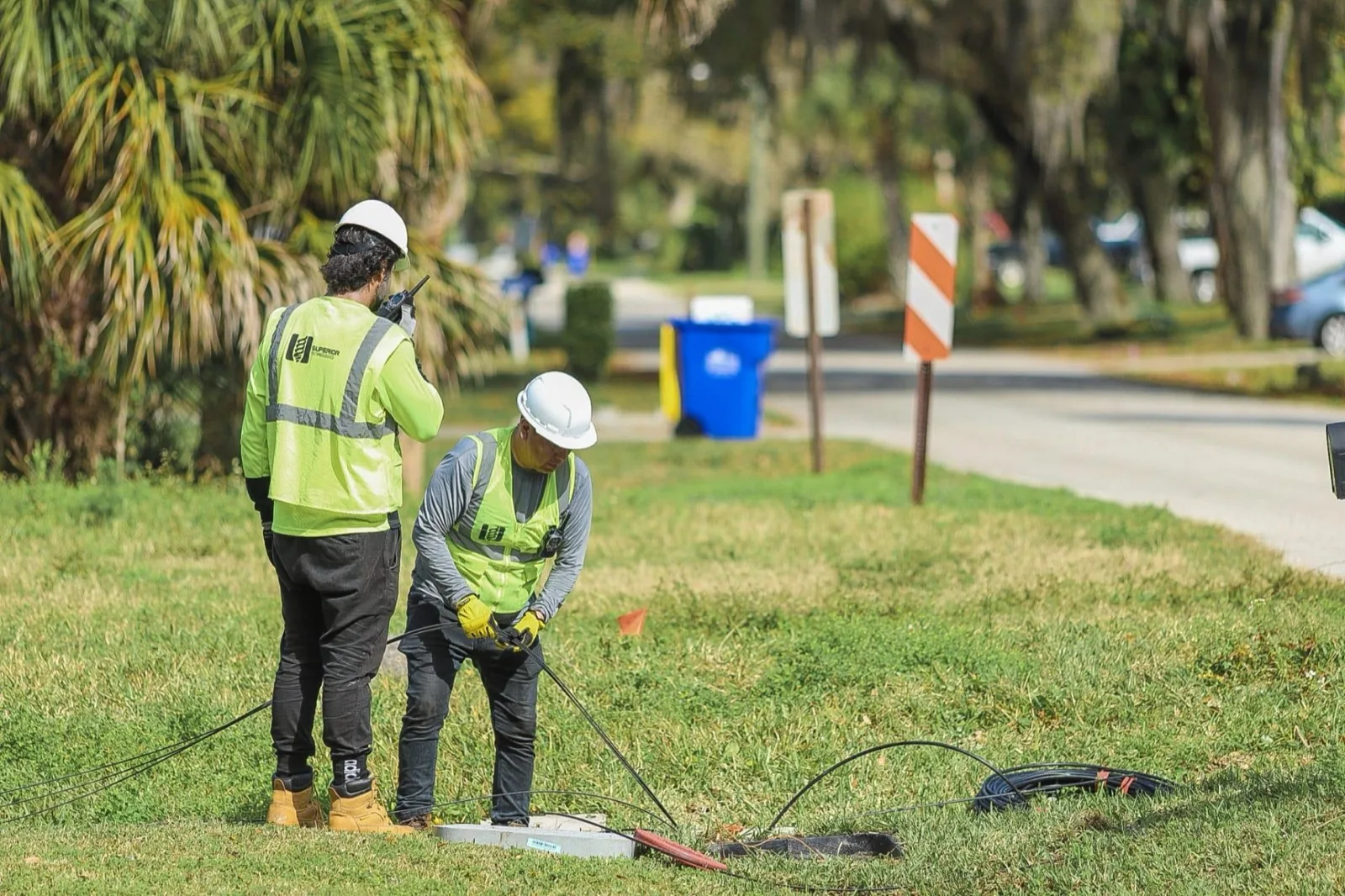 Superior Technologies crew placing fiber drop in a residential right of way