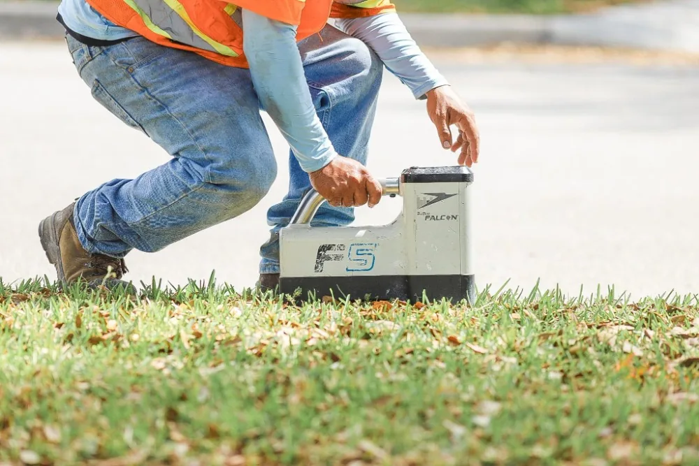 Technician setting a utility locator to trace the bore path