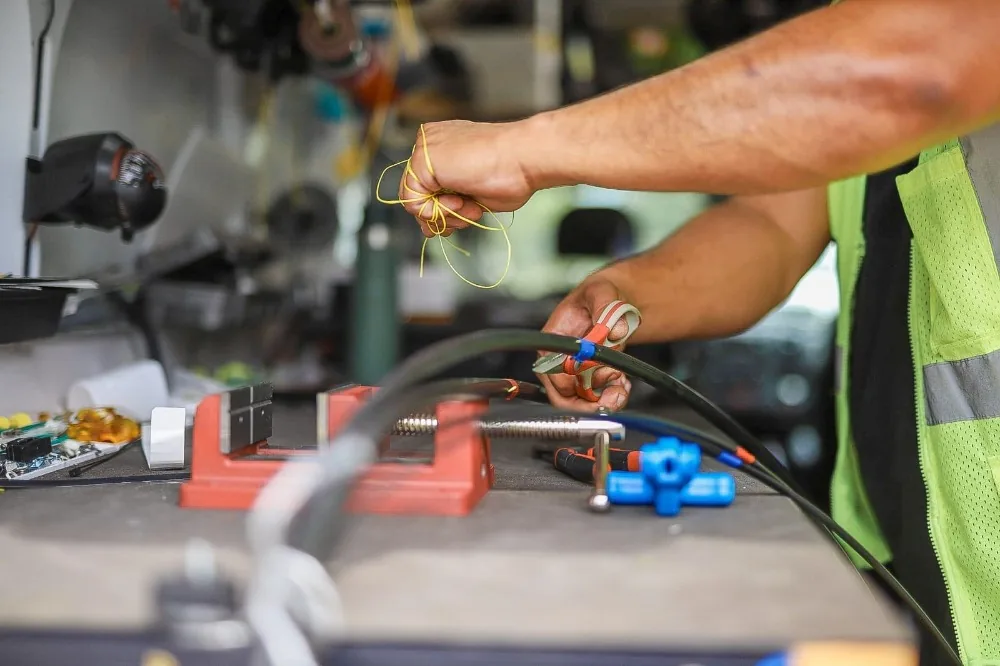 Technician preparing fiber cable at the service van workbench