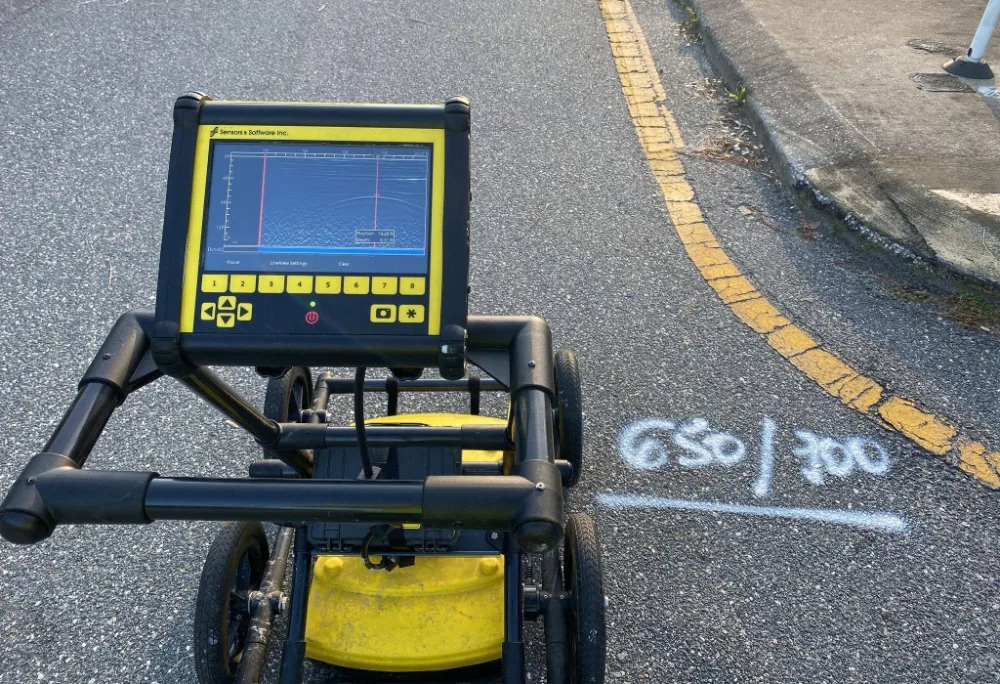Ground penetrating radar scanning marked pavement before excavation