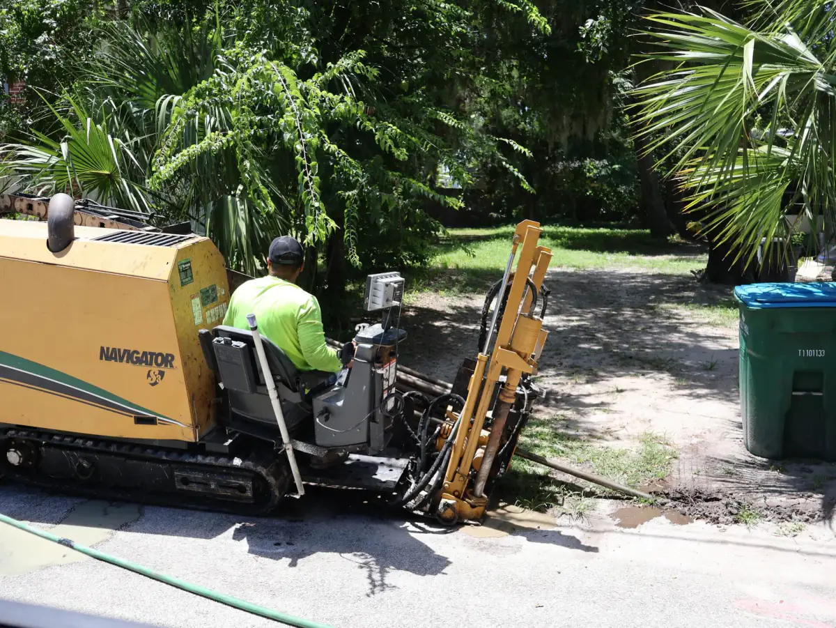 Directional drill advancing a bore under a residential lot